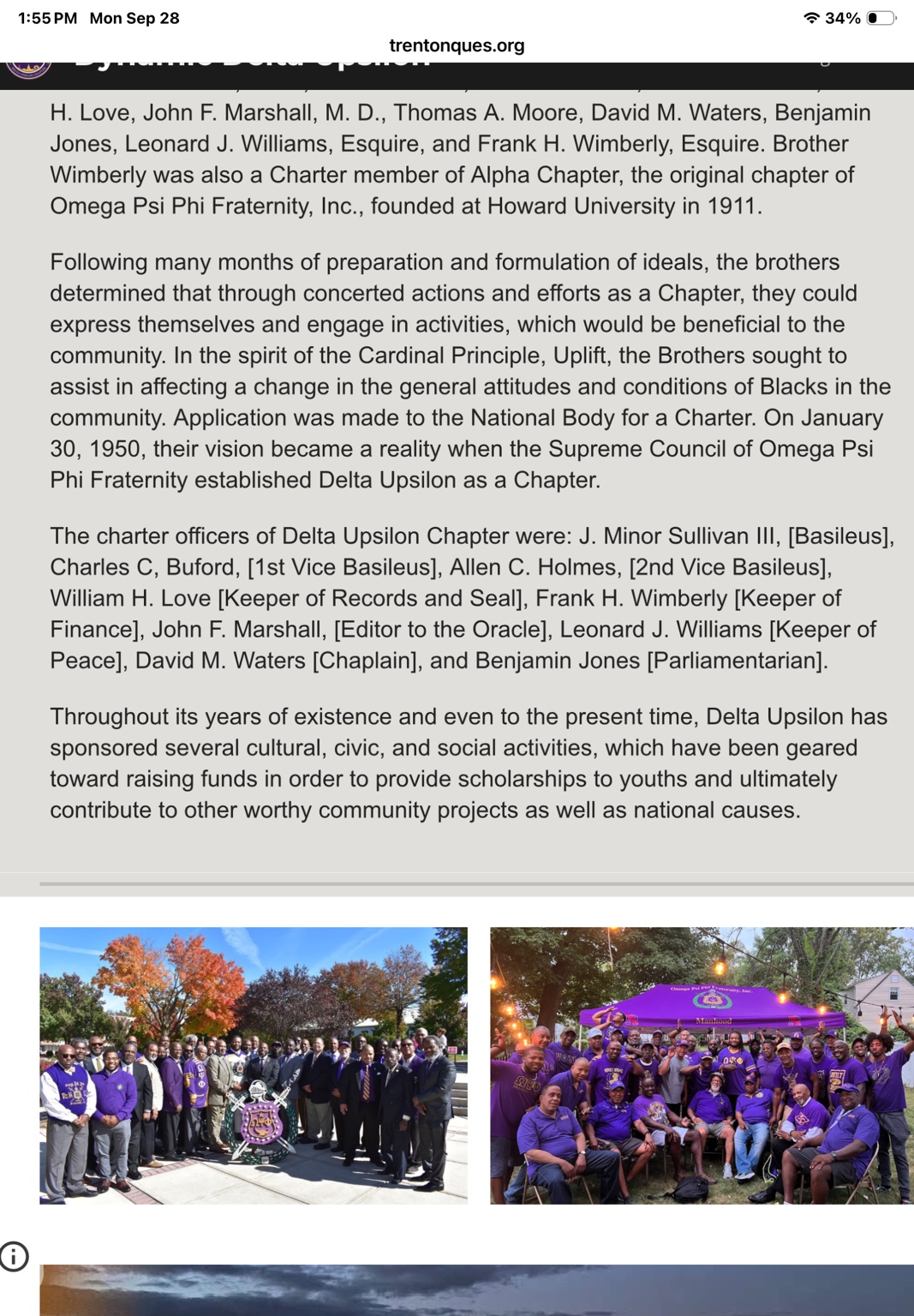 Chapter members gathered outdoors around a fraternity display