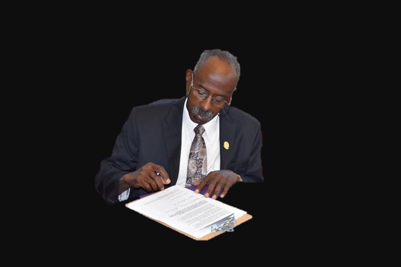 Lawrence Graves Sr. signing a document